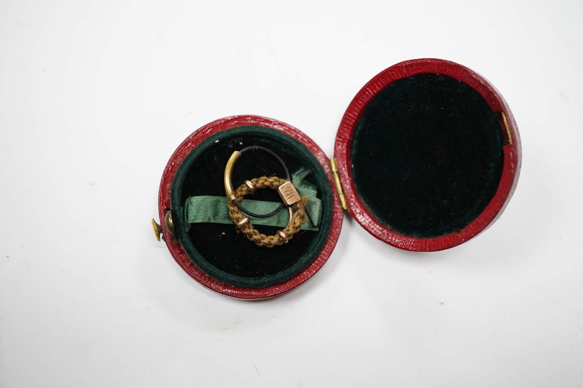 An early 19th century hairwork brooch, with engraved initials and a small hairwork ring. Condition - fair.